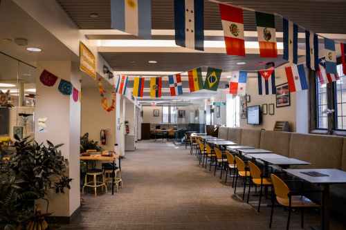 The current cultural centers layout in the basement of ARCH. Photo shows tables set up on the right side of the hallway and flags from Latin countries hung from the ceiling. Photo courtesy of The Daily Pennsylvanian.